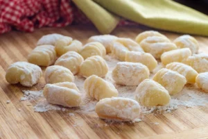 Gnocchi maison façonnés disposés sur un plan de travail fariné